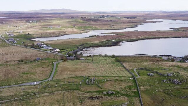 Advancing aerial shot of the ancient Callanish Standing Stones on the Isle of Lewis, part of the Outer Hebrides of Scotland. The stones are neolithic, first erected more than 4 millennia ago.
