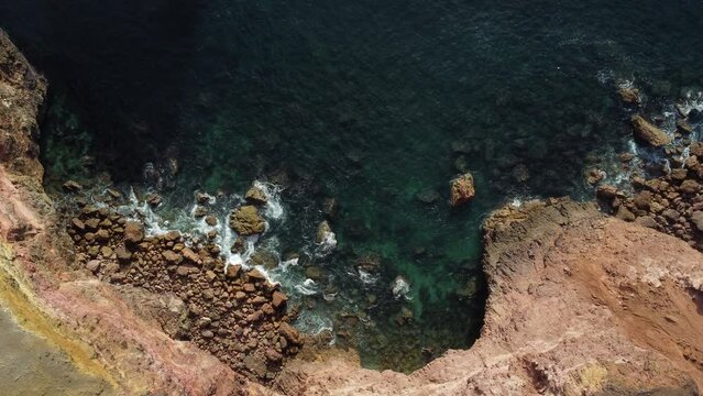 topdown view of Rocky coastline with fog in the Portugal Southeast