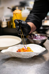 chef cooking Seviche with salmon on kitchen