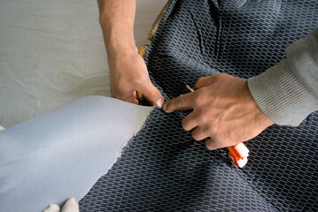 The master prepares the material for pasting the side cards of the car. Car care and detailing. Car...