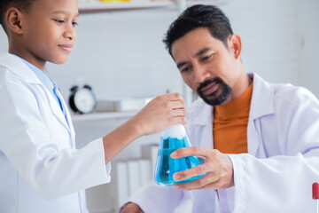 Curiosity African Asian primary school boy student wearing lab coats happy studying with chemical teacher analyzing substance liquid test in laboratory room, lifestyle learning education science class