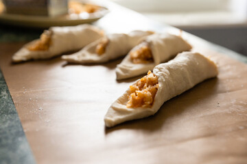 The first culinary experience. Cooking at home. The first pies with apple filling