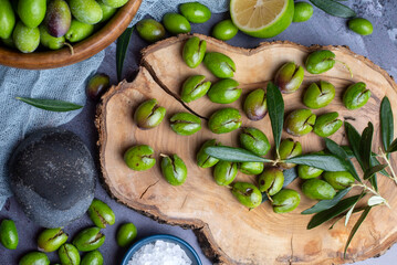 Homemade crushing olive making. Fresh green olives are breaking one by one. Crushing olives with stone. Preparing pickled olives in Turkish style. (Turkish name; kirma zeytin)