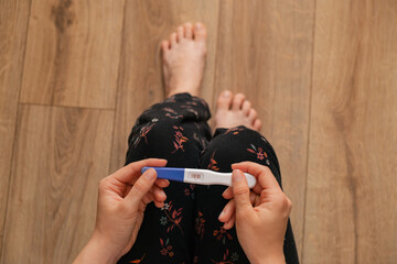 positive pregnancy test in woman hand close up
