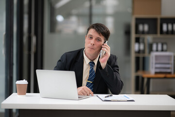 Businessman talking to customers online together at the office.