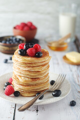 Pancakes with berries in rustic style