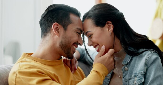 Couple, forehead touch and kiss on sofa with love, bonding and happy people together at home. Healthy relationship, trust and support in commitment, partner and marriage with romance and intimacy