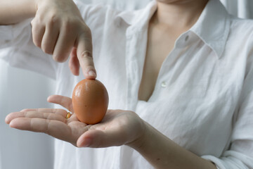 A person holding eggs in hand, Person holding eggs for commercial purpose - 640572967