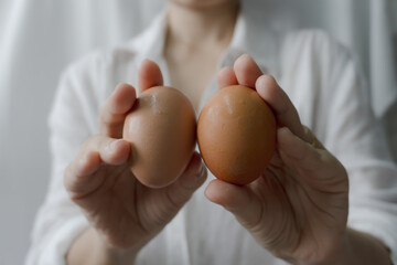 A person holding eggs in hand, Person holding eggs for commercial purpose