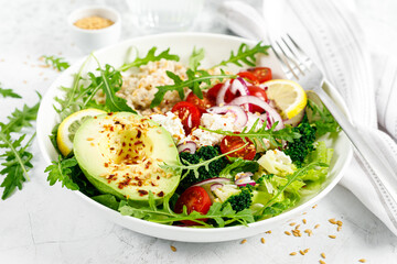 Oatmeal porridge with avocado, cottage cheese, tomatoes, fresh green salad and arugula. Healthy...