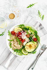 Oatmeal porridge with avocado, cottage cheese, tomatoes, fresh green salad and arugula. Healthy breakfast. Top view