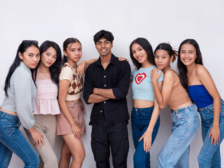 A young handsome and dapper indian guy in the center together with 6 attractive asian ladies. 7...