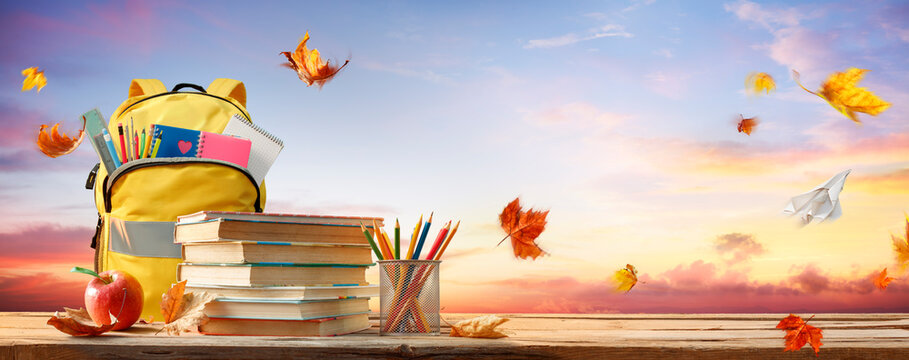 Back To School - Schoolbag And Books With Pencils And Stationary On Autumn Table With Leaves
