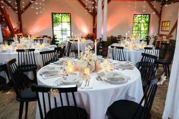 Beautiful table setting and decorations at a wedding. Wedding venue with beautiful decor, flowers,...