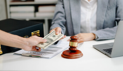 justice and law concept.passing bribe money in the envelop at lawyer office. businessman hand...