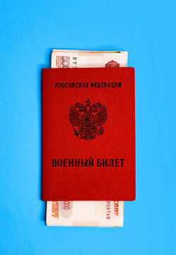 Russian red book military ID with bills of 5 thousand rubles on a blue background, mockup. Concept: corruption, bribe, mobilization, military service, pay off, buy shoulder straps, rank in the army
