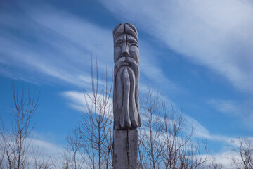 Wooden totem with a sky background