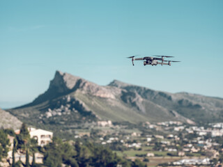 Fototapeta na wymiar Drone flying over town and mountains