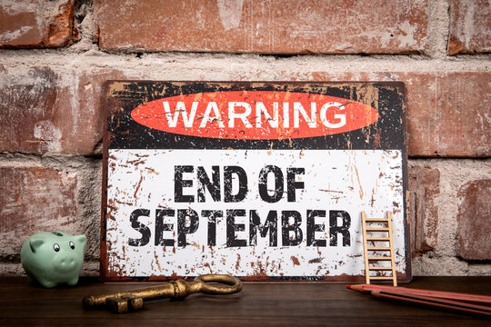 END OF SEPTEMBER. Warning sign on wooden office desk