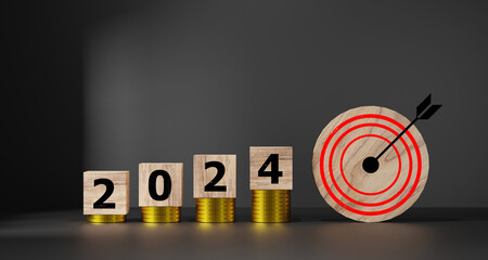 2024 target business cost and budget planning.Wooden cubes with 2024 and goal icon on coins stack....