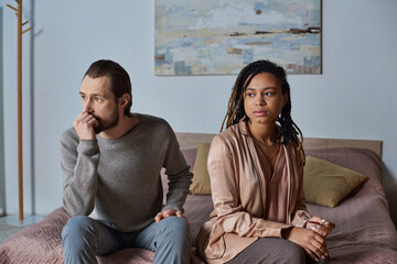 upset african american woman holding pregnancy test near boyfriend, interracial couple, abortion