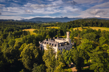 Aerial view of Karpniki Palace and Giant Mountains in Lower Silesia- captured in summer day. This place is local atraction.