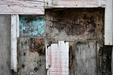 Different kind of old, weathered  wooden planks. An old entrance door in Singapore.