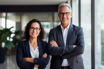 Foto op Plexiglas Happy confident professional mature business man and business woman corporate leaders managers standing in office, two diverse colleagues executives team posing together, portrait © wolfhound911