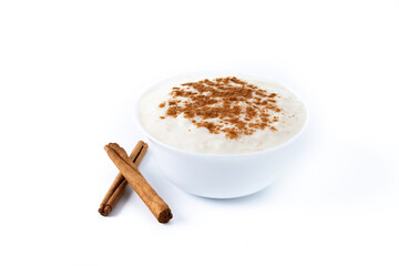 Arroz con leche. Rice pudding with cinnamon in clay bowl isolated on white background.