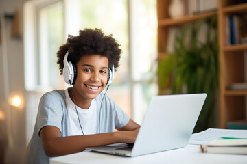 Happy African American teen student elearning at home on pc, writing notes. Smiling teenage girl using laptop watching webinar, hybrid learning english online virtual class, sitting at home table