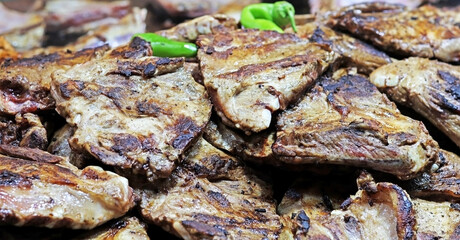 Grilled beef or pork on a barbecue. Selective focus.