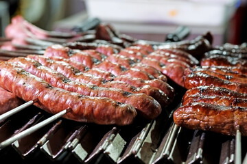 Grilled Creole sausages on a barbecue. Selective focus.