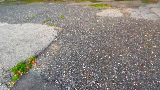 Close up of worn and broken asphalt
