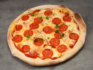 american pepperoni pizza on a gray background