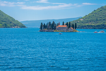 Island Saint George with medieval monastery in the Bay of Kotor near Perast town on Adriatic sea in Montenegro in sunny day. Popular summer vacation destination