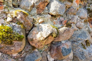 Ancient medieval stone wall texture background. The wall is partially collapsed