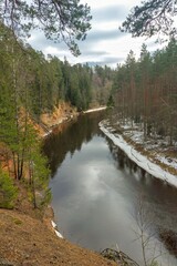 Fototapeta na wymiar The banks of the river Salaca. Skanaiskalna nature park. Some ice on the shores in Latvia, Mazsalaca