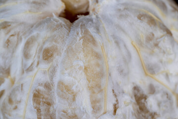 peeled pomelo on the table, close up