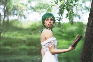 elegant green-haired girl reading a book in the quiet of a green park.women in a green surreal atmosphere