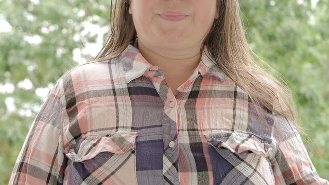 excitedly woman 50 years old in plaid shirt holds to heart, sudden chest pain, expression suffering, emotional distress, Ischemic heart disease, Arterial hypertension, Myocarditis or Arrhythmia