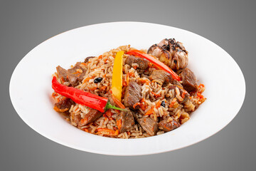 Uzbek-style pilaf on a decorative plate. Isolated