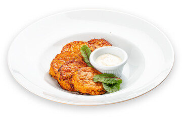 Pumpkin cutlets with white sauce. Vegetarian dish. Isolated image on a white background.