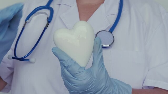 female scientist, doctor holding heart model, health medical technology, diagnosis and treatment heart disease, medical humanism concept, cardiology, intensive care, resuscitation