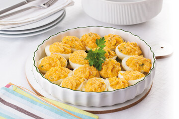 Deviled eggs with mustard and yolk on a tray, one serving
