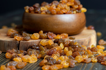 Dried yellow golden raisins on a board