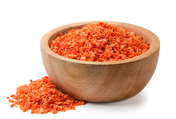 Dried carrots in a wooden plate and scattered on a white background. Isolated