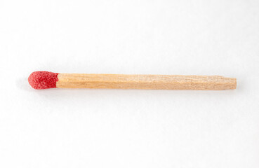 Red match stick on white background.