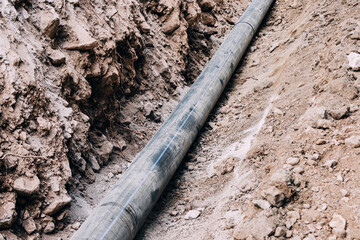 industrial progress, with pipes and tubes laid underground in a construction site, showcasing the...