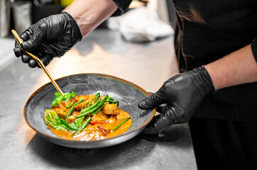 chef hand cooking Chicken curry on kitchen