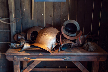 Body armor in a pile in and old blacksmith shop in a museum. Human protection equipment from brutal...